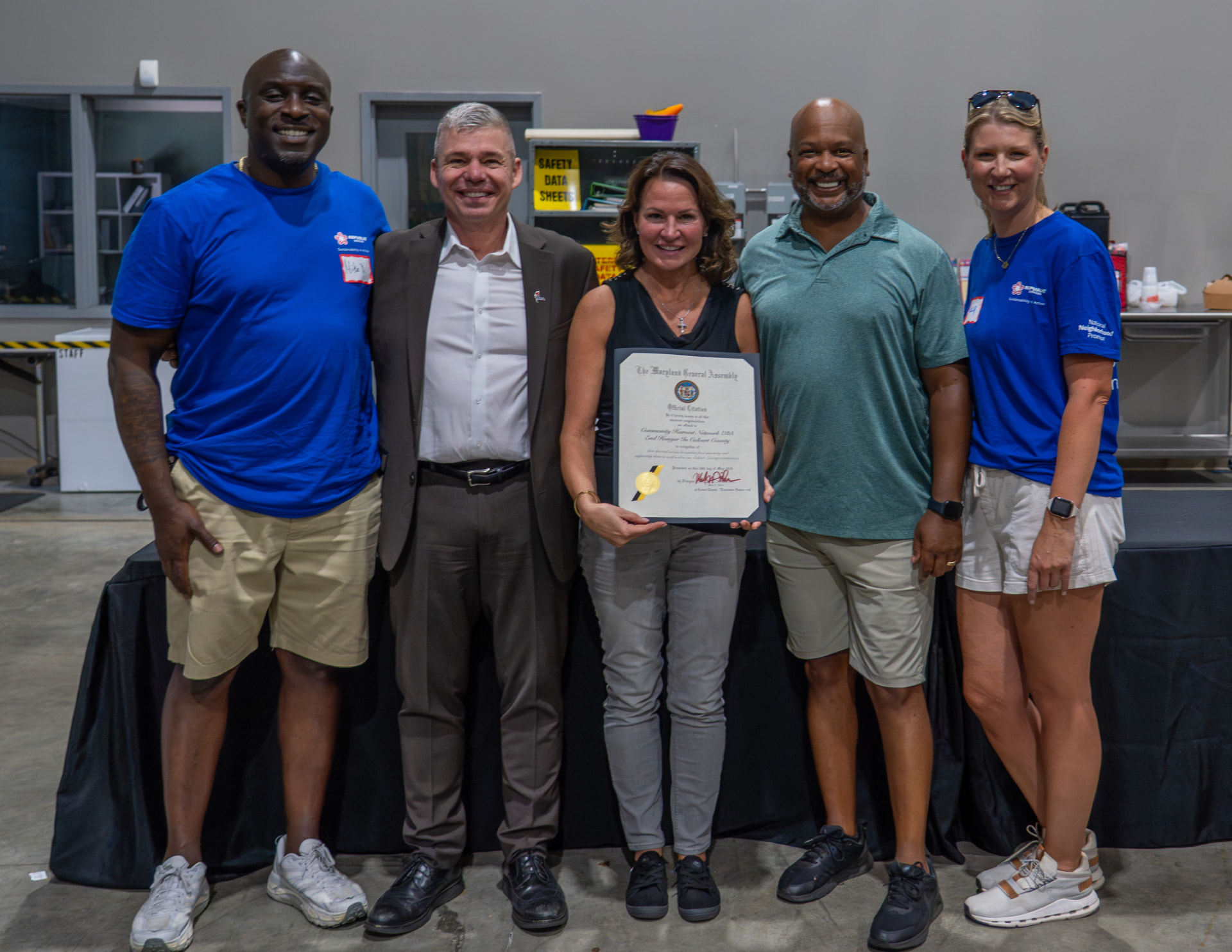 Delegate Mark Fisher presenting an Official Citation from the Maryland General Assembly to Community Harvest Network leaders and Republic Services partners